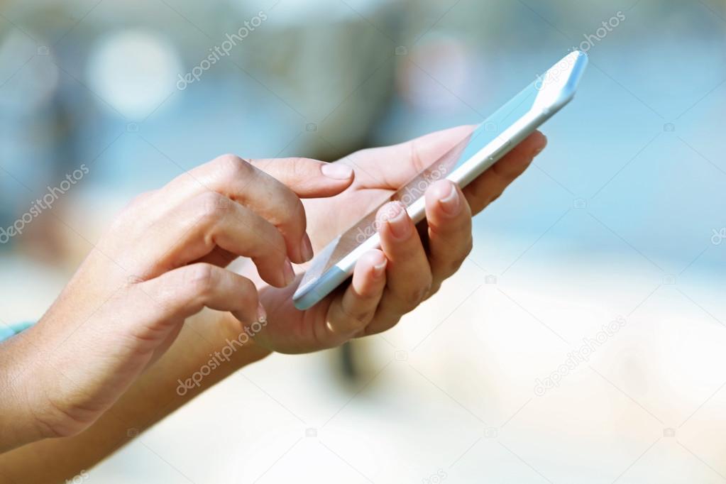 Female hands holding a mobile phone