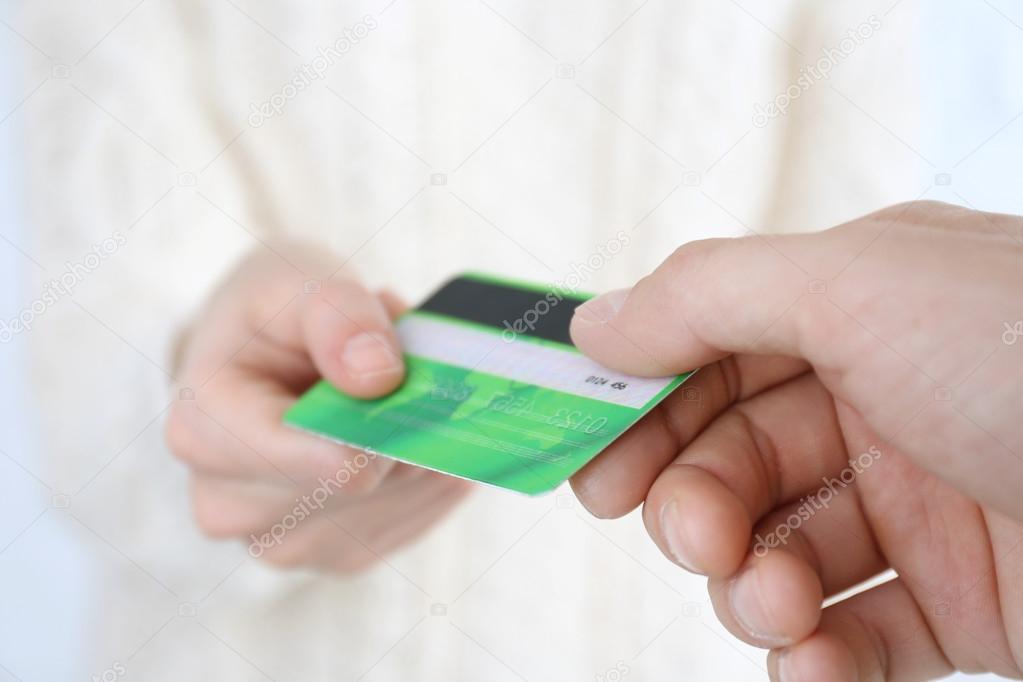 Hands holding a credit card