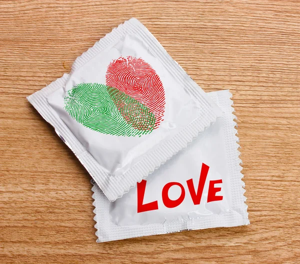 Condoms with pictures on  table — Stock Photo, Image