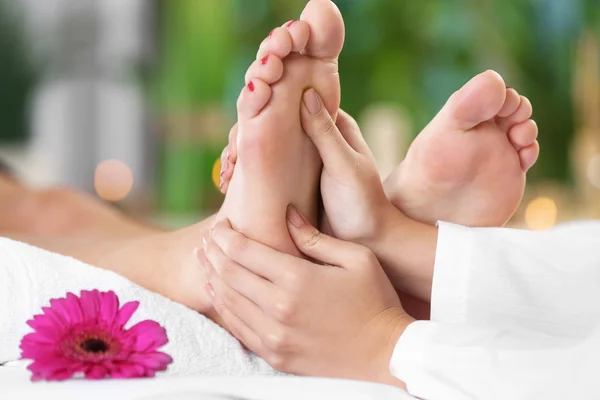 Beautiful young woman relaxing with leg massage at beauty spa — Stock Photo, Image