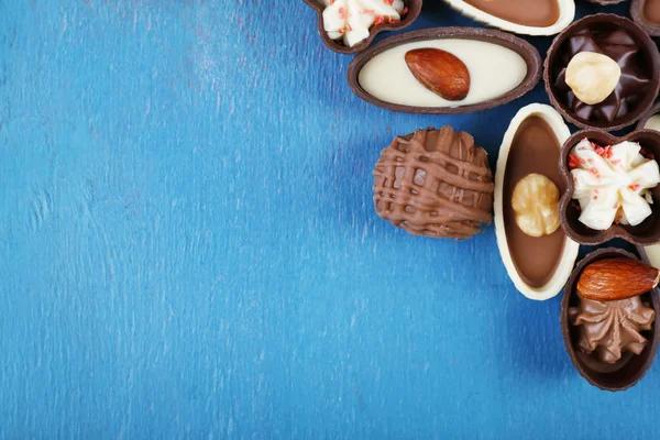 Chocolate sweets on old blue wooden background, top view — Stock Photo, Image