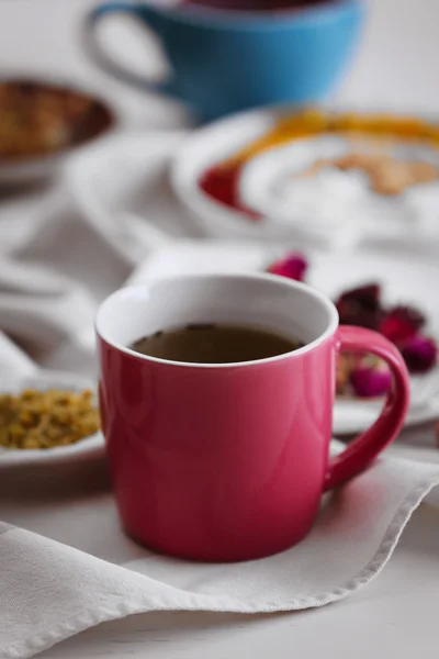 Cup of tea with aromatic dry tea on wooden background — Stock Photo, Image