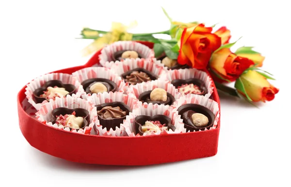 Heart shaped box with candies and flowers, isolated on white — Stock Photo, Image