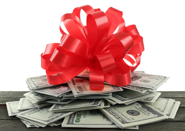 Pile of dollars with bow as gift isolated on white — Stock Photo, Image