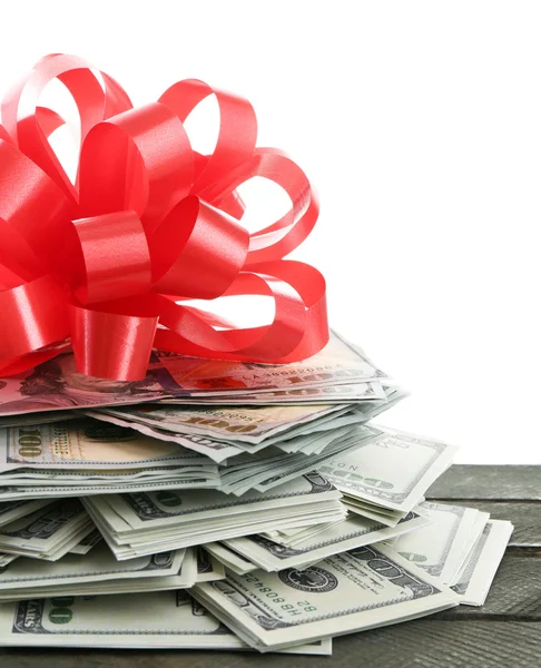 Pile of dollars with bow as gift isolated on white — Stock Photo, Image