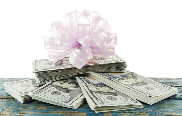 Pile of dollars with bow as gift isolated on white — Stock Photo, Image