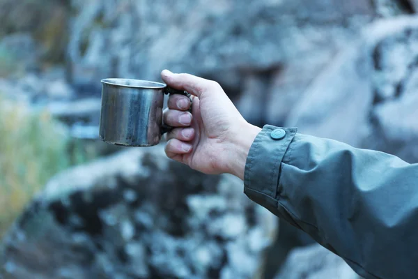 Man holding mug of hot drink — Stock Photo, Image