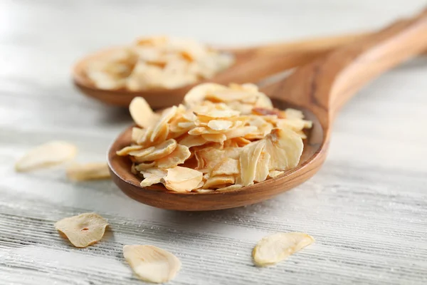 Two wooden spoons with almond flakes — Stock Photo, Image