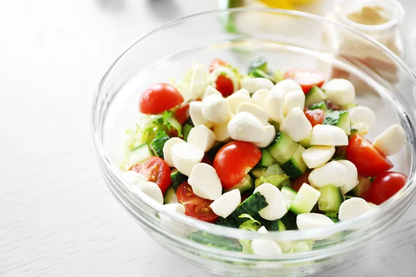 Tasty salad in glass dish — Stock Photo, Image