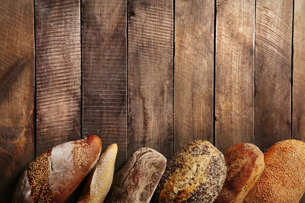 Bread on wooden background — Stock Photo, Image