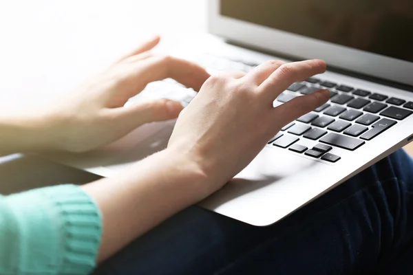 Mulher sentada no sofá com laptop — Fotografia de Stock