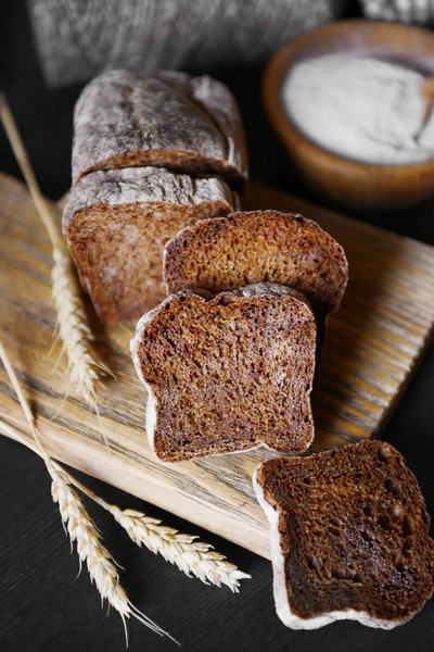 Sliced bread with ears on cutting board closeup — Stock Photo, Image