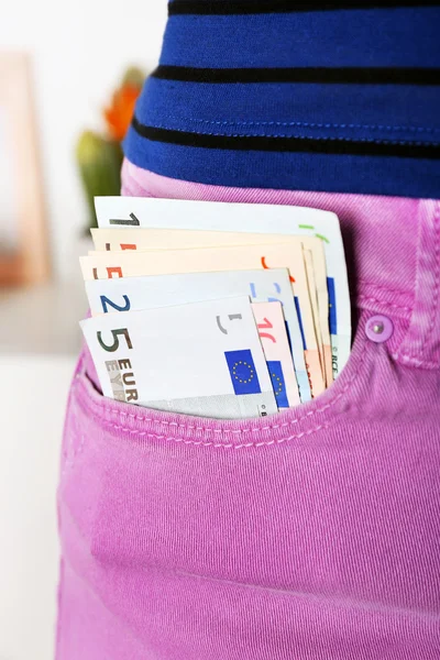 Euro money in pocket violet pants — Stock Photo, Image