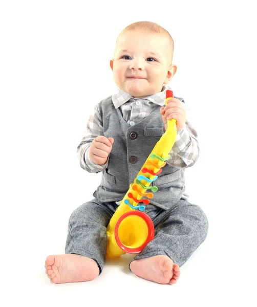 Adorable baby with plastic colourful saxophone — Stock Photo, Image