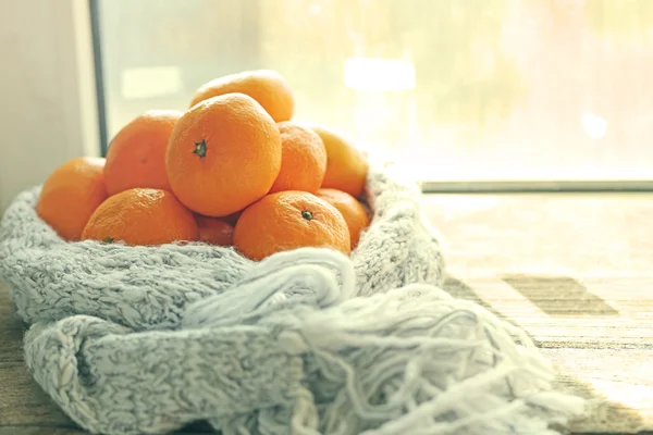 Tangerines on old wooden table, on window background — Stock Photo, Image