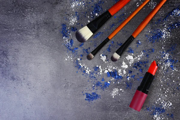 Three makeup brushes and red lipstick — Stock Photo, Image