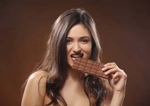 Attractive young woman with chocolate — Stock Photo, Image