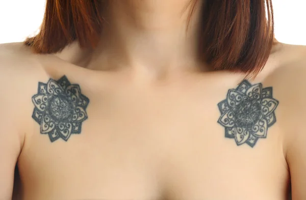 Flower tattoos on female shoulders on white background