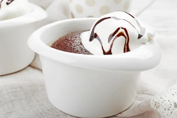 Chocolate lava cake with ice-cream in bowls, on the table — Stock Photo, Image