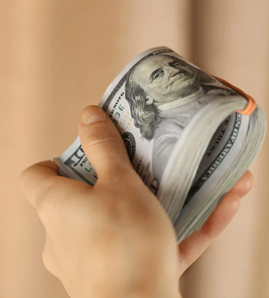 Hand holding a pack of dollars — Stock Photo, Image