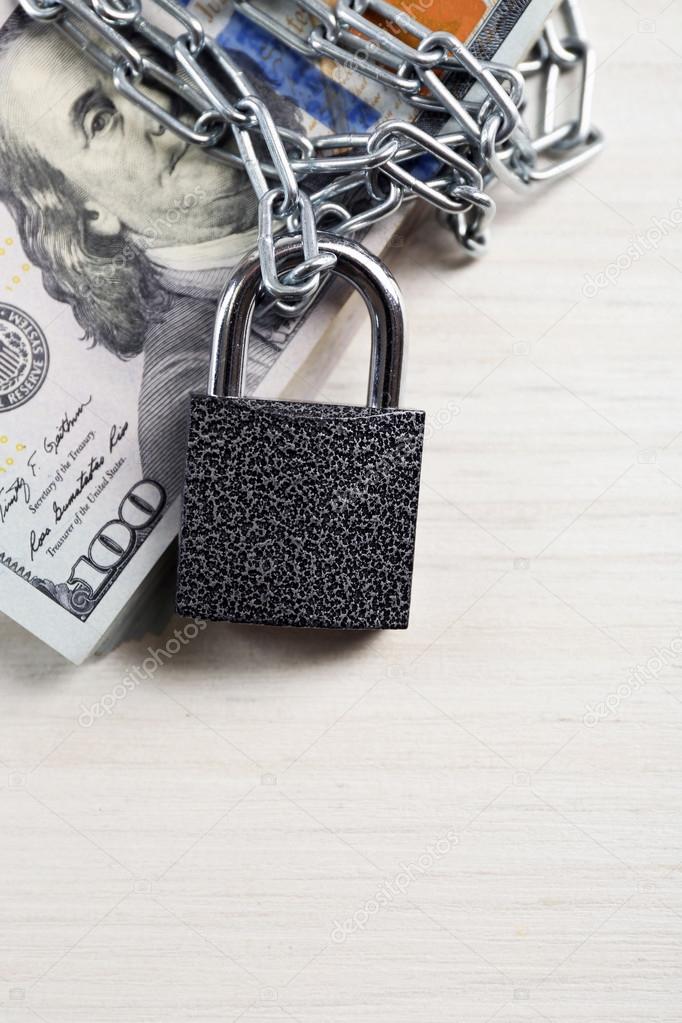 Dollars currency with lock and chain 