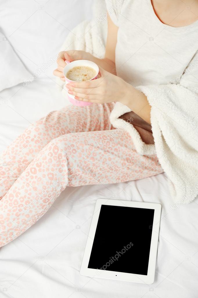 Woman in pajamas with tablet