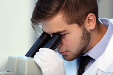 Serious clinician studying chemical element in laboratory