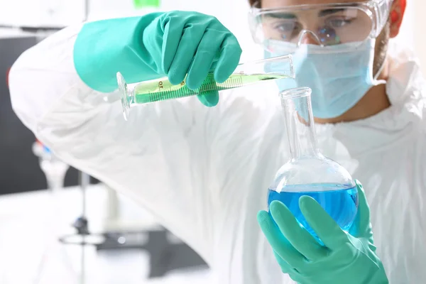 Man in laboratory checking test tubes — Stock Photo, Image