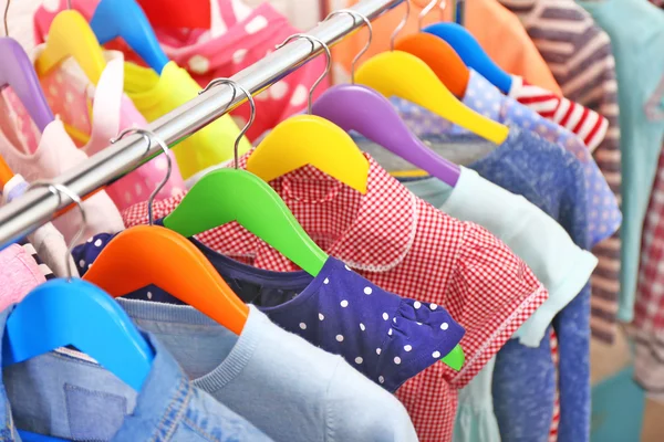 Clothes for kids on hangers — Stock Photo, Image