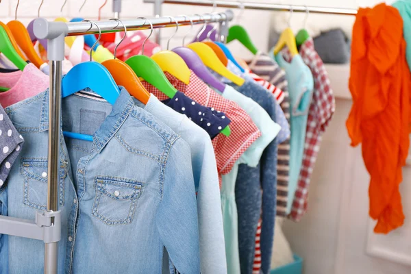 Clothes for kids on hangers — Stock Photo, Image