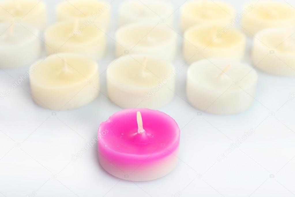 Pink and white small candles, isolated on white