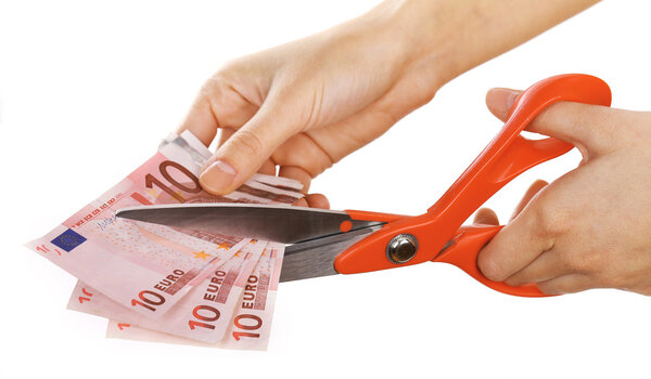 Hands with scissors cutting Euro