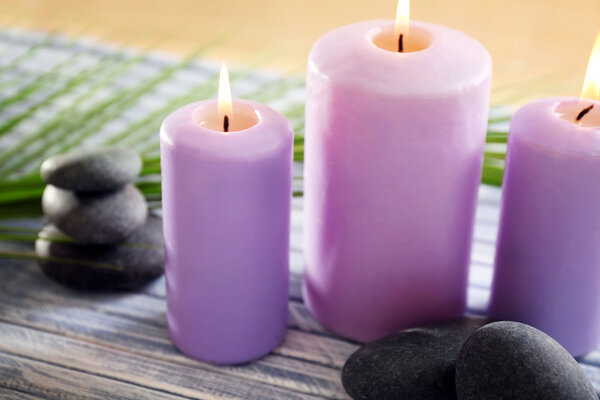 Purple candles with spa stones