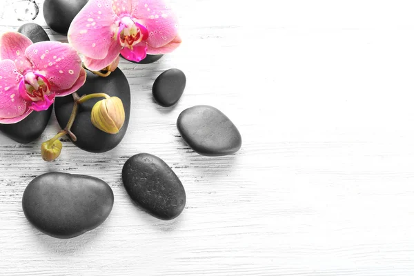 Beautiful composition of orchid and pebbles — Stock Photo, Image