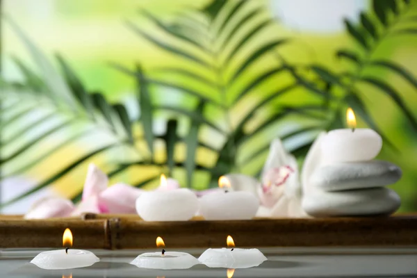 Spa still life with candles in water — Stock Photo, Image