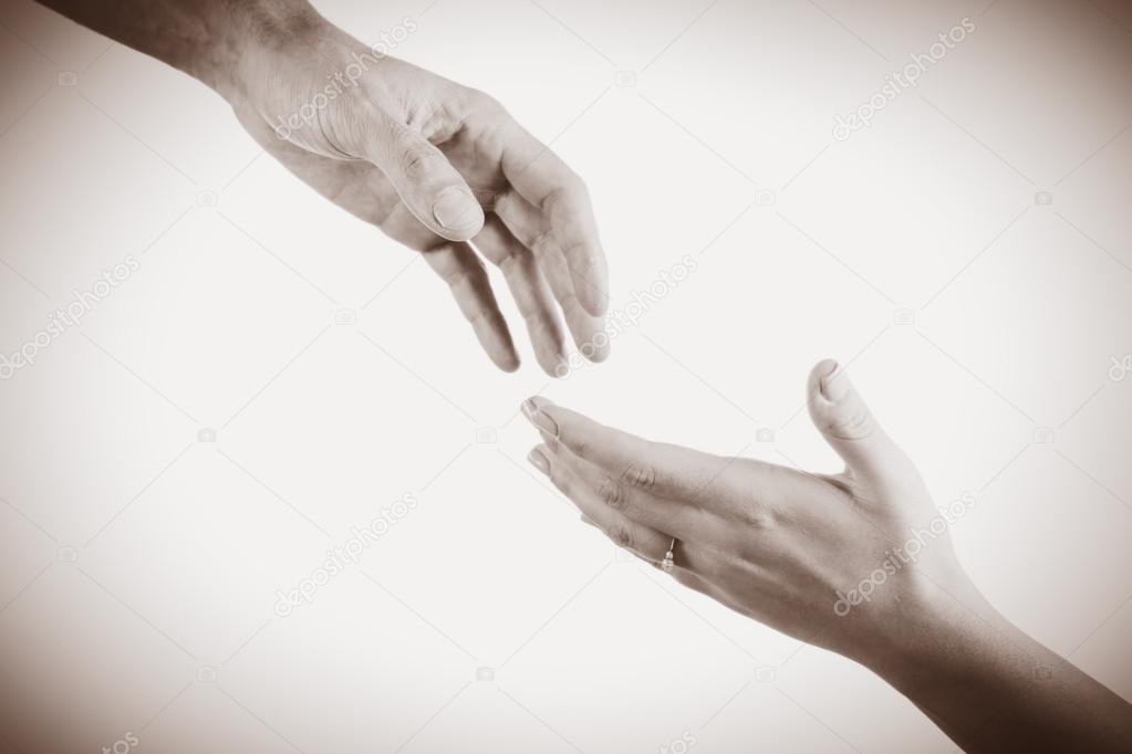 Hands reaching toward each other