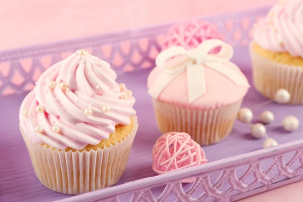 Pocos cupcakes sabrosos en cesta con decoraciones, primer plano —  Fotos de Stock