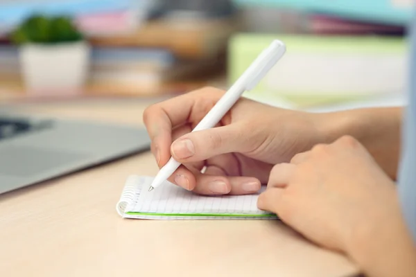 Woman making notes in notebook — Stock Photo, Image