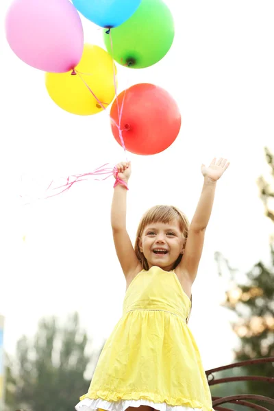 Little girl with balloons — Stock Photo, Image