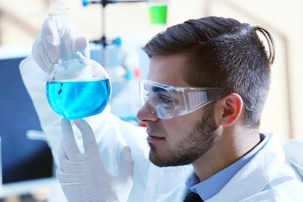 Hombre en laboratorio con prueba — Foto de Stock