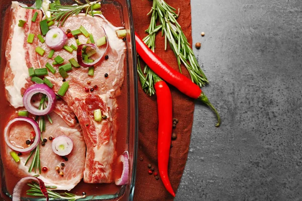 Marinating meat with spices on table, close up — Stock Photo, Image