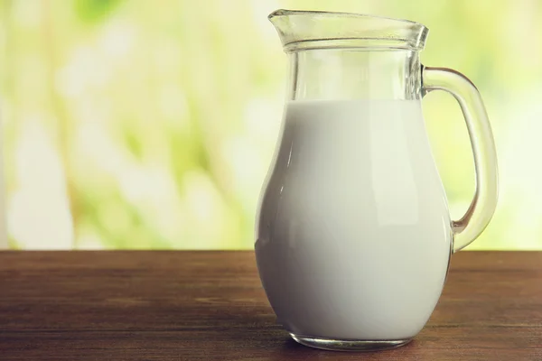 Jar of milk on natural background — Stock Photo, Image