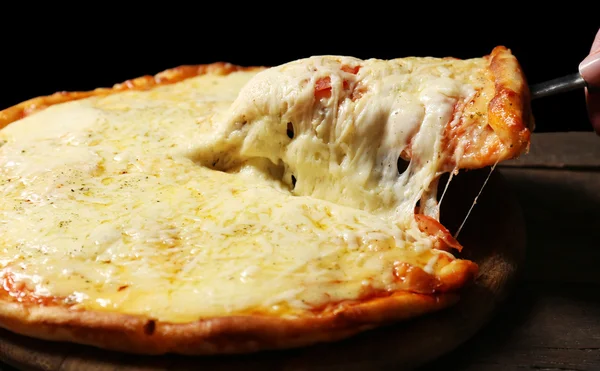 Tasty sliced pizza on wooden table, close up — Stock Photo, Image