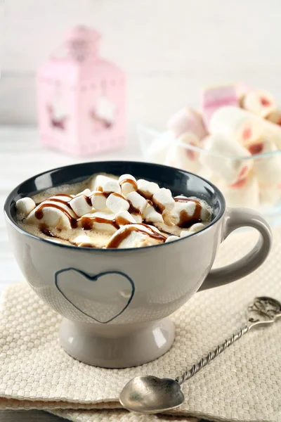 Mug of hot chocolate with marshmallows, on light wooden background — Stock Photo, Image