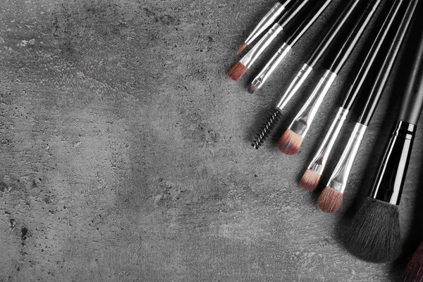 Makeup brushes on gray — Stock Photo, Image