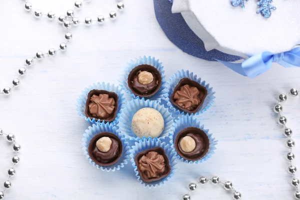 Set of chocolate candies on a light wooden background — Stock Photo, Image