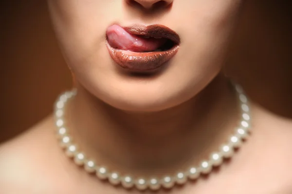 Woman licking her chocolate lips — Stock Photo, Image