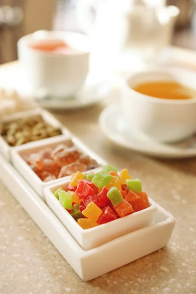 Set of candies and tea on table close up — Stock Photo, Image