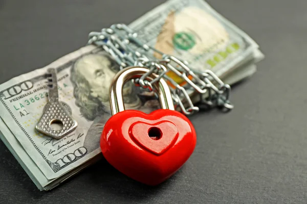 Dollars with heart shaped lock and chain — Stock Photo, Image