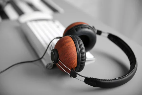 Headphones on grey table — Stock Photo, Image
